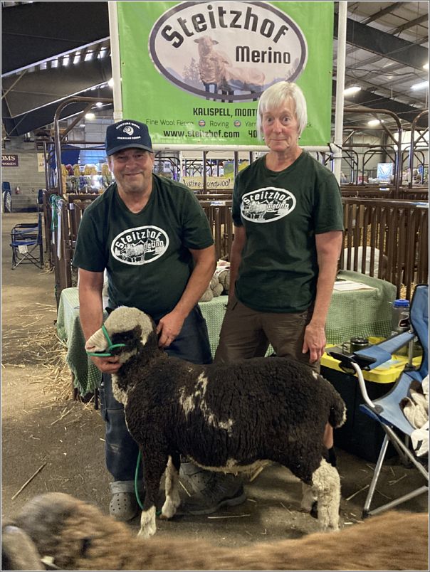 John and Carol Steitz, of Steitzhof Merinos, Kalispell, Montana, showing their Merino in their vendor booth. Photo: Evelyn Taylor.